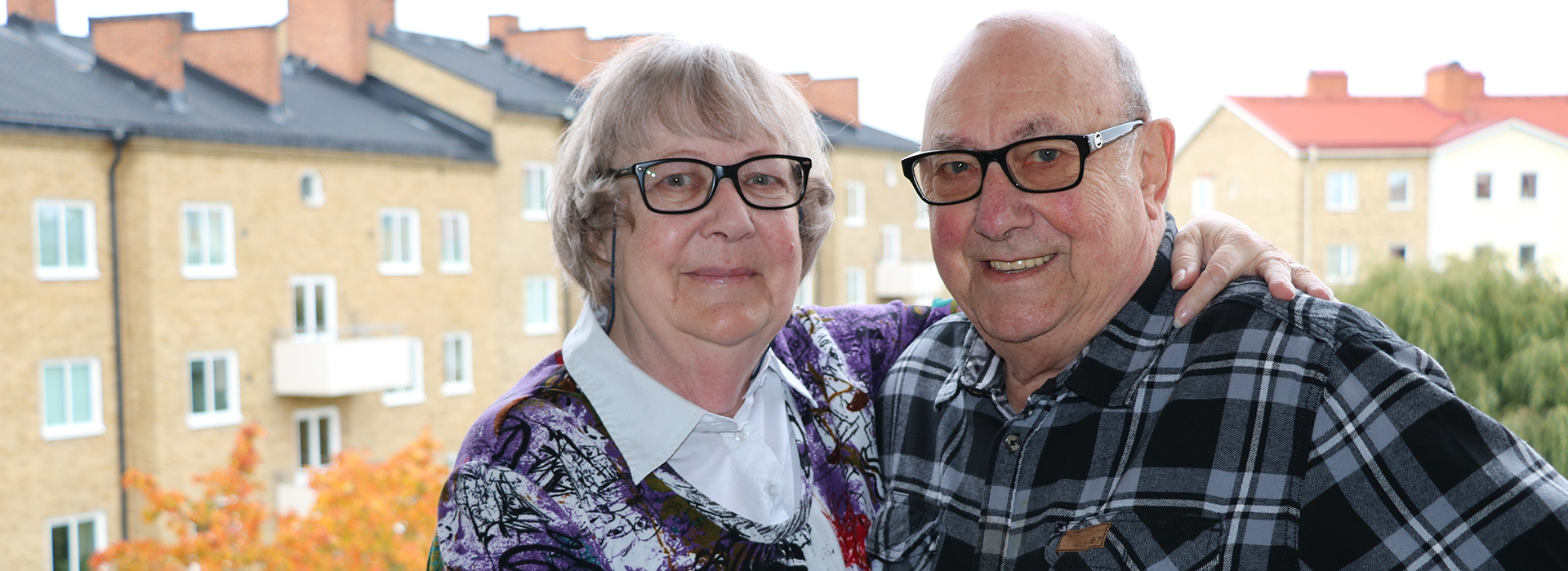 Ett äldre par står på en balkong