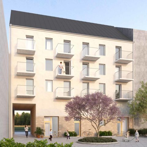 Ett bostadshus på 4 våningar i ljus puts