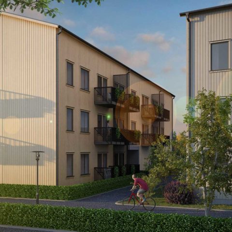Ett bostadshus med grönska runt om
