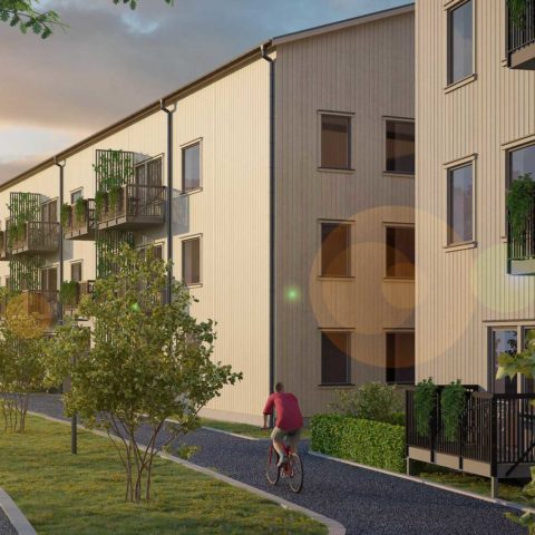 Ett bostadshus med grönska runt om