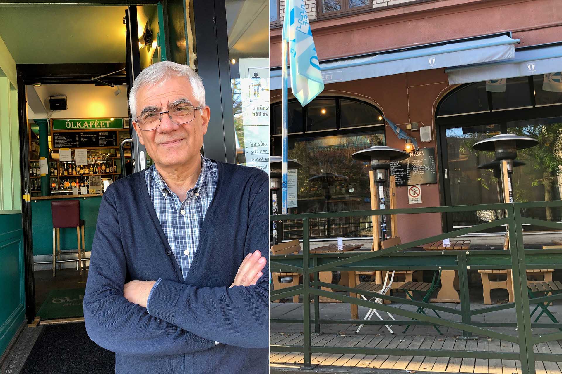 En gråhårig man med en rutig skjorta och en blå cardigan står med armarna i kors framför en pub