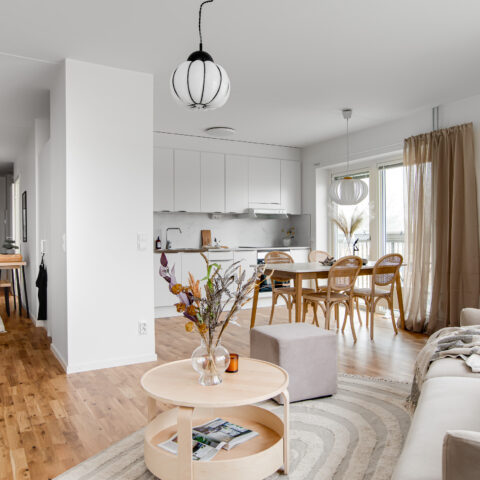 interiör vy där man ser vardagsrum, kök och gång mot hallen