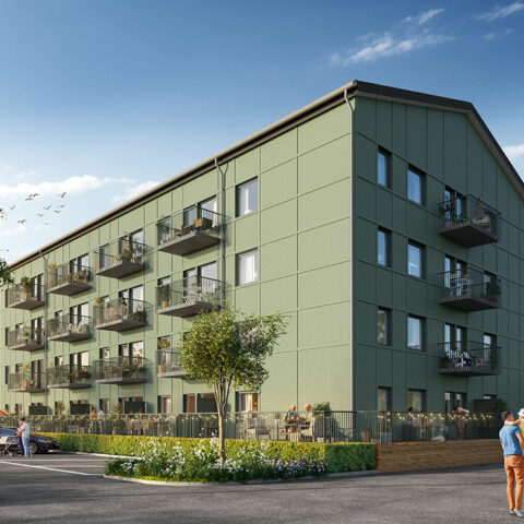 Fasadbild av det grönmålade trähuset med Balkonger mot parkering.