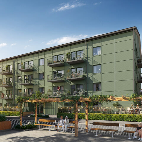 Fasadbild på det grönmålade huset, Hus A i Storfågeln med balkong mot innergården.