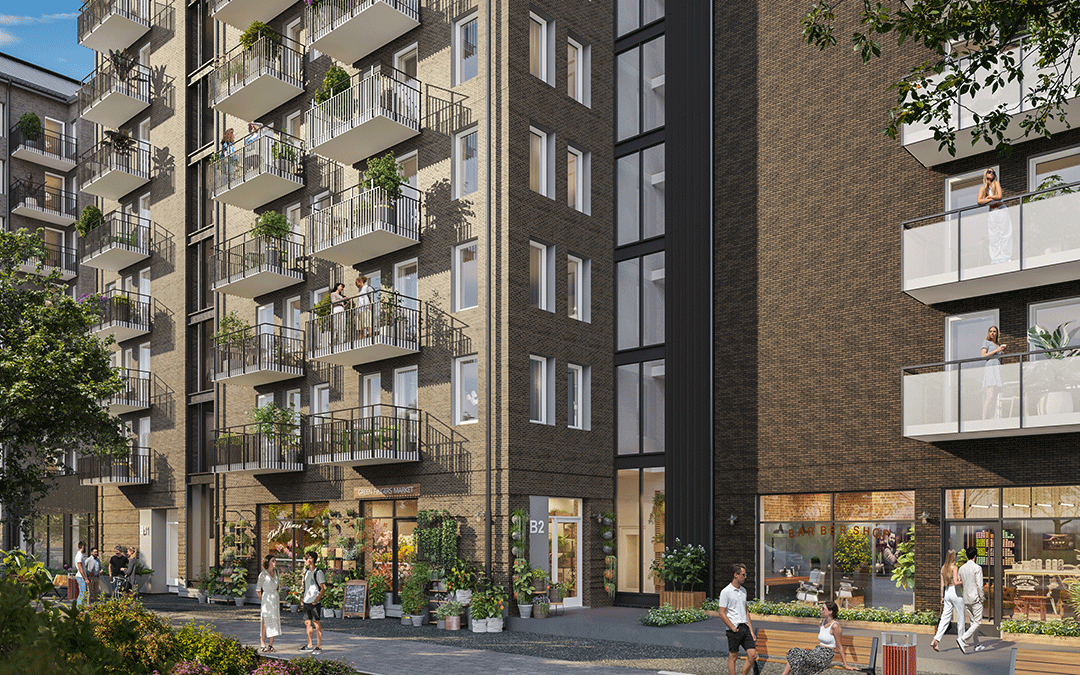 En brun tegelfasad med balkonger och butiker i bottenplan.