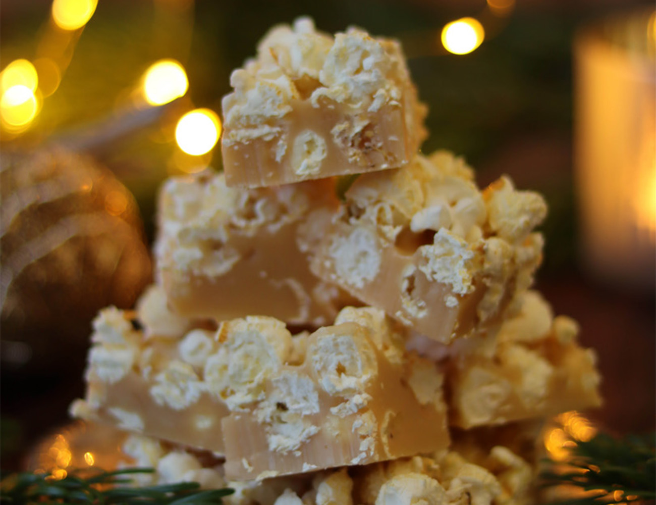 A dish with light fudge pieces in which there is popcorn.